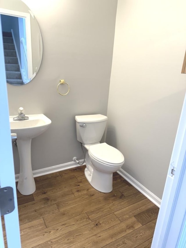 bathroom with hardwood / wood-style flooring, sink, and toilet