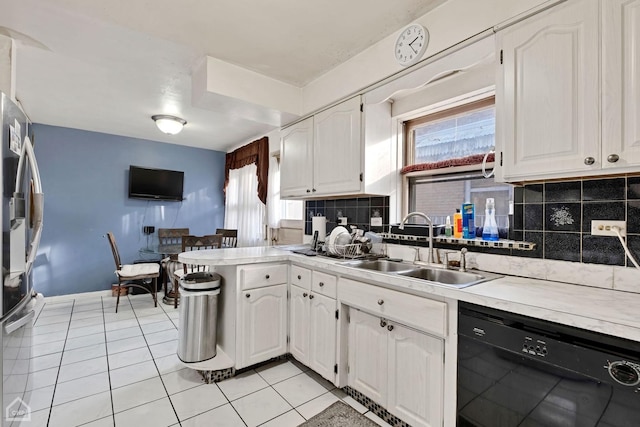 kitchen with sink, white cabinetry, black dishwasher, and kitchen peninsula