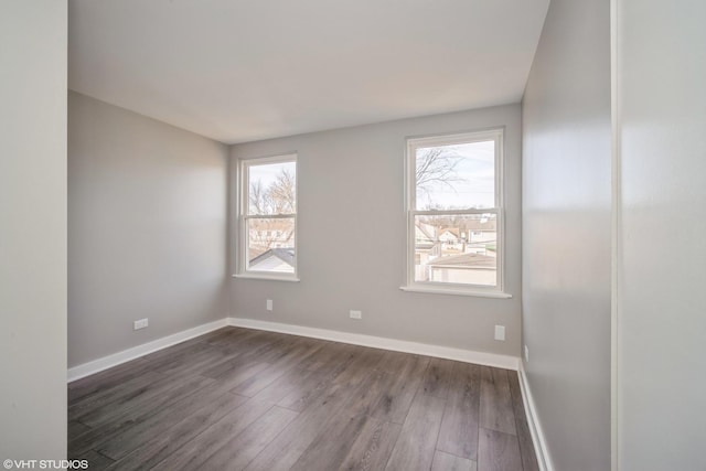 empty room with wood finished floors and baseboards