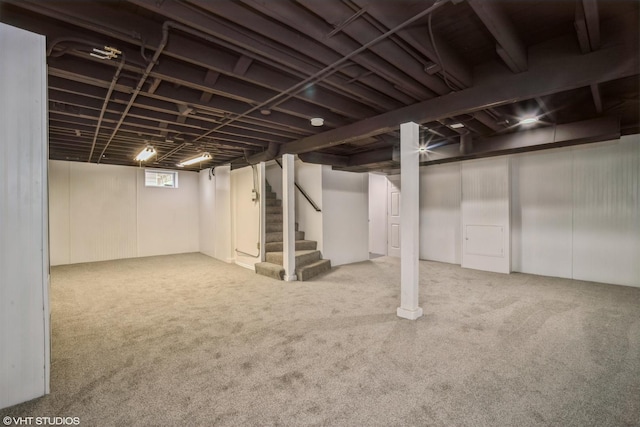 below grade area with stairs and carpet flooring