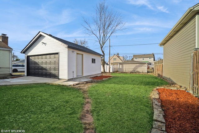 view of yard with an outbuilding, fence, and a garage