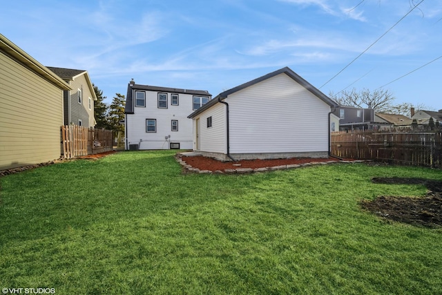 rear view of property with cooling unit, fence, and a lawn