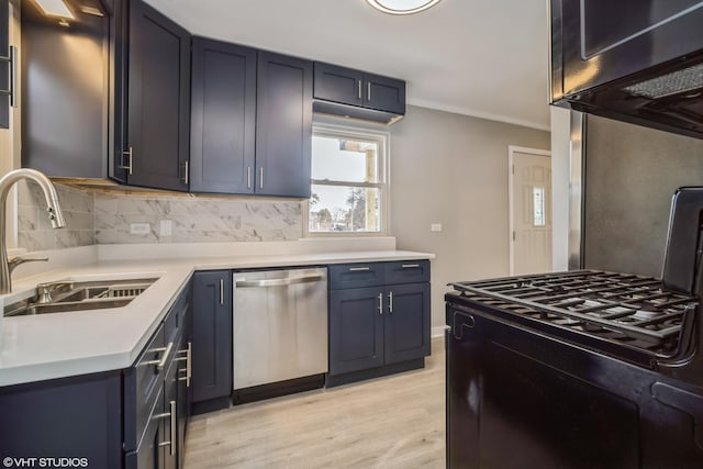 kitchen featuring black gas range oven, tasteful backsplash, stainless steel dishwasher, and a sink