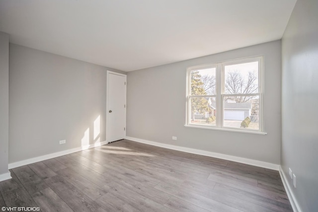 empty room with wood finished floors and baseboards