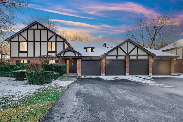 tudor-style house featuring a garage