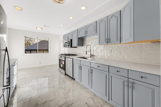 kitchen featuring tasteful backsplash, sink, and appliances with stainless steel finishes