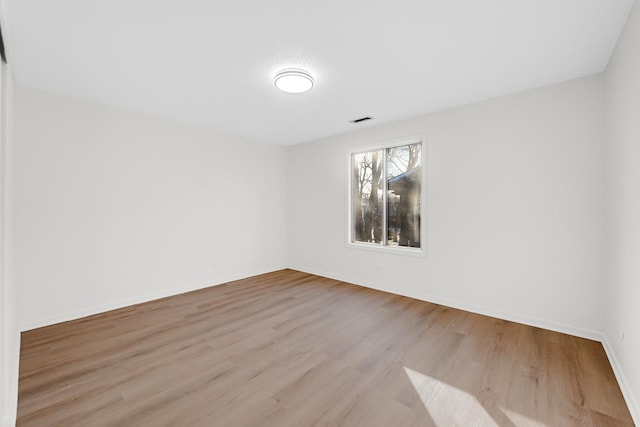 unfurnished room with light wood-type flooring