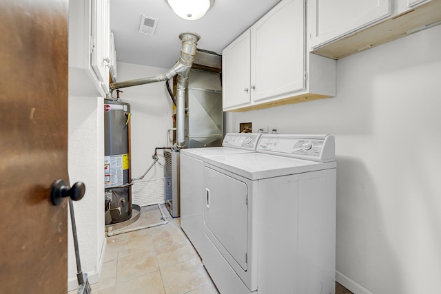 clothes washing area featuring water heater, light tile patterned floors, washing machine and dryer, and cabinets