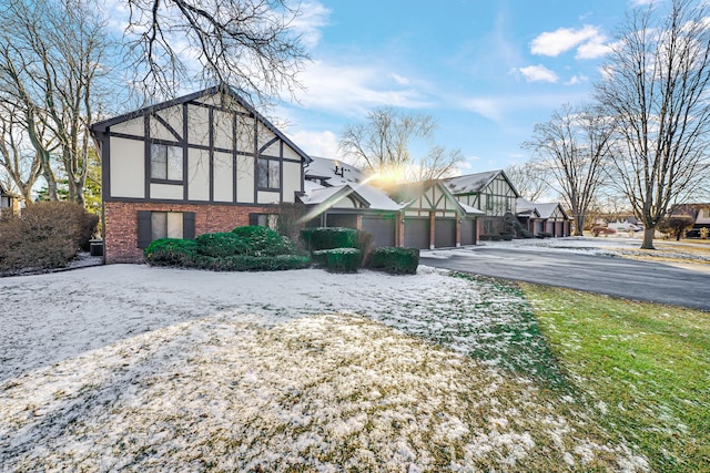 view of snowy exterior with a garage