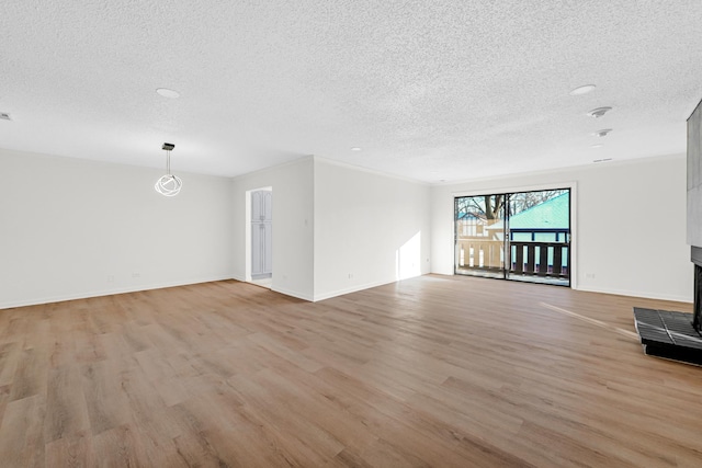 unfurnished living room featuring a textured ceiling and light wood-type flooring