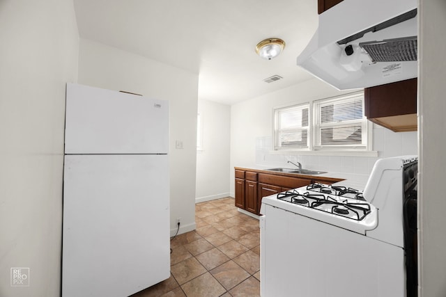 kitchen with sink, tasteful backsplash, light tile patterned flooring, white appliances, and range hood