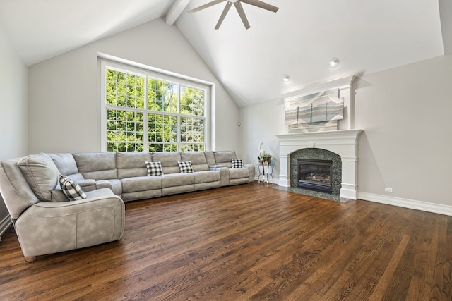 living room with a fireplace with flush hearth, beam ceiling, wood finished floors, baseboards, and ceiling fan