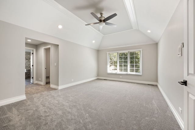 spare room featuring carpet flooring, ceiling fan, baseboards, and vaulted ceiling