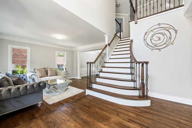 stairway featuring wood finished floors, baseboards, and ornamental molding