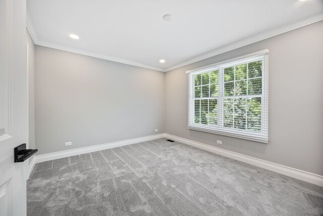 carpeted spare room with recessed lighting, crown molding, and baseboards