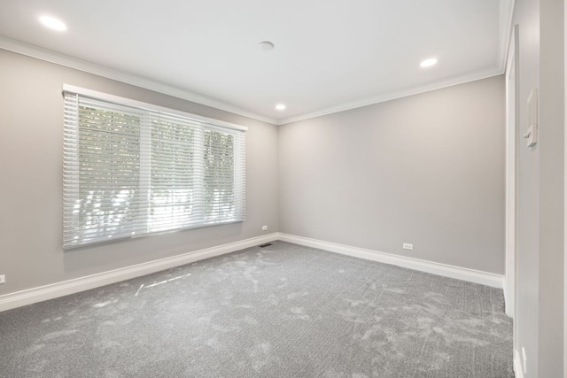 carpeted empty room with baseboards and ornamental molding