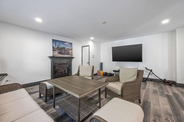 living room with recessed lighting, baseboards, wood finished floors, and a fireplace