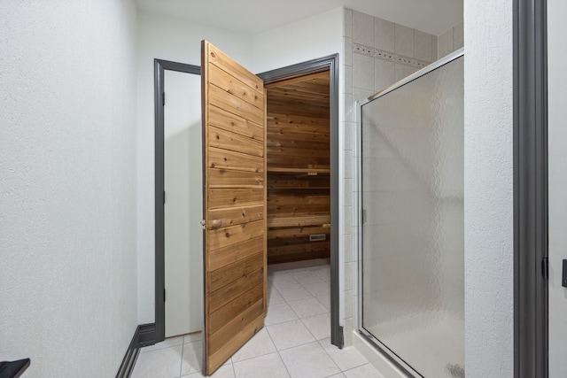 full bathroom with tile patterned floors and a shower stall