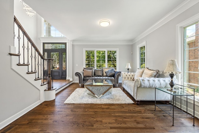 living area with a healthy amount of sunlight, dark wood finished floors, stairs, and ornamental molding