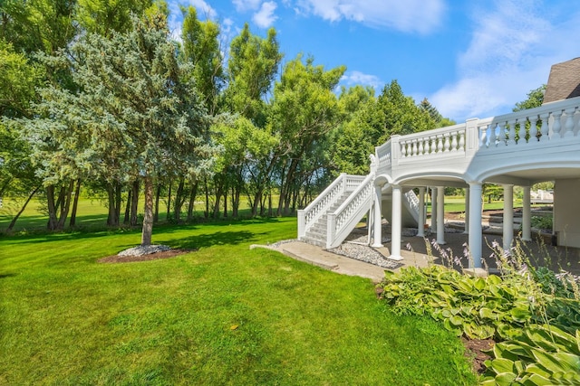 view of yard featuring a deck and stairway