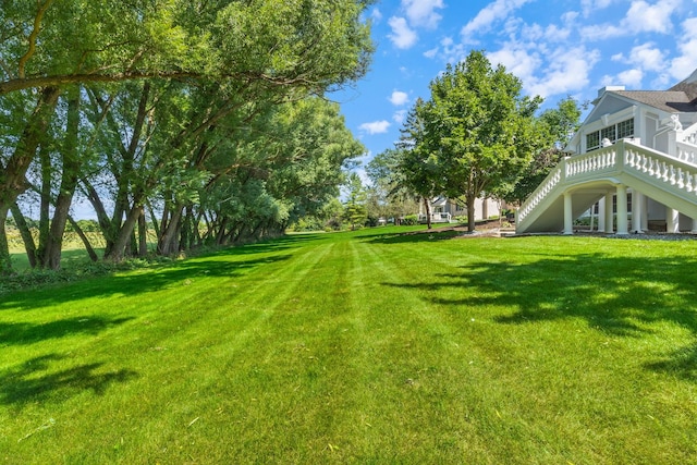 view of yard featuring a deck and stairway