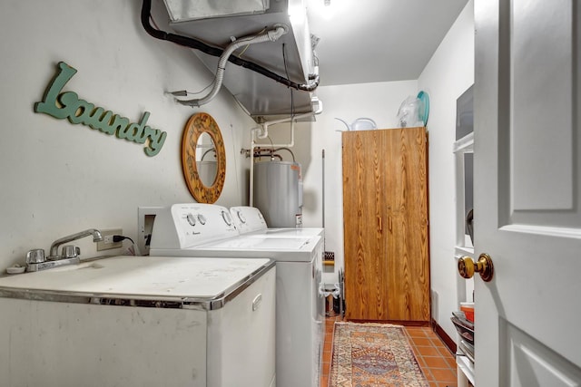 laundry room with tile patterned flooring, sink, washing machine and dryer, and water heater