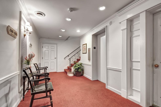 corridor featuring ornamental molding, carpet, and elevator