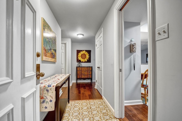 hallway with dark hardwood / wood-style floors