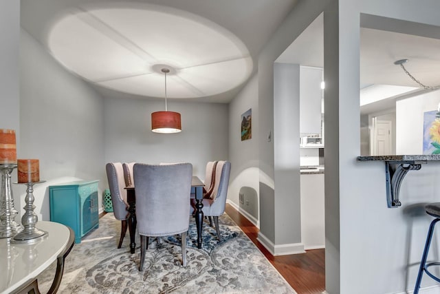 dining room with dark wood-type flooring