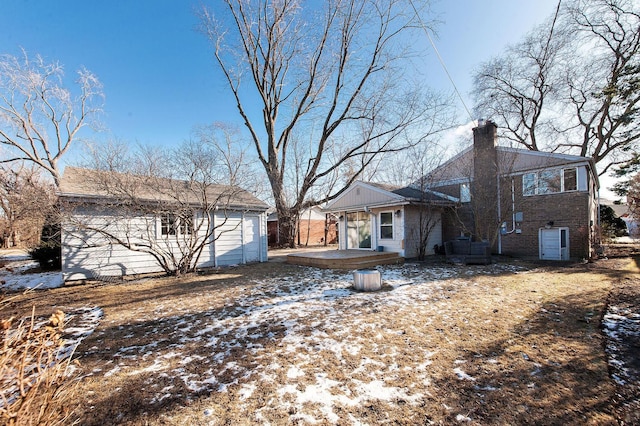 view of snow covered rear of property