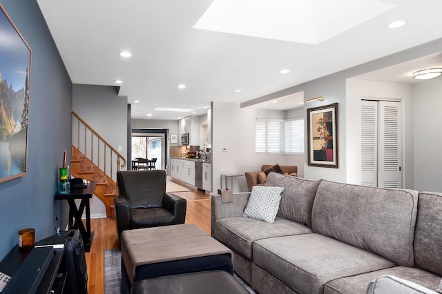 living room featuring light wood-type flooring and plenty of natural light