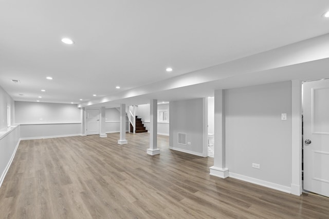 basement with light hardwood / wood-style flooring