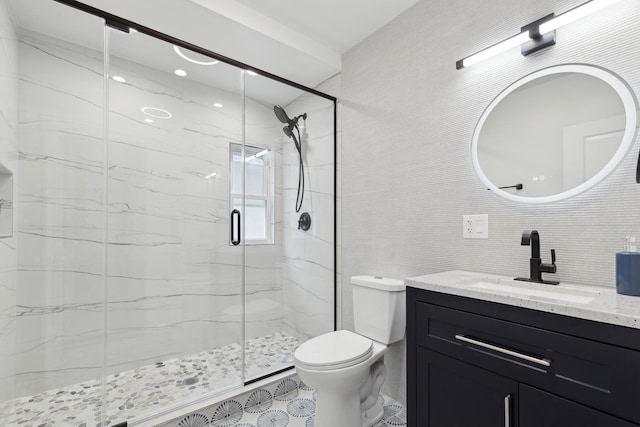 bathroom featuring tile walls, vanity, tasteful backsplash, a shower with shower door, and toilet