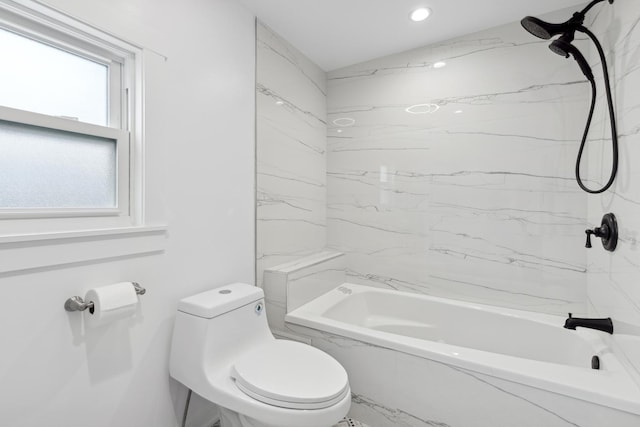 bathroom featuring tiled shower / bath and toilet