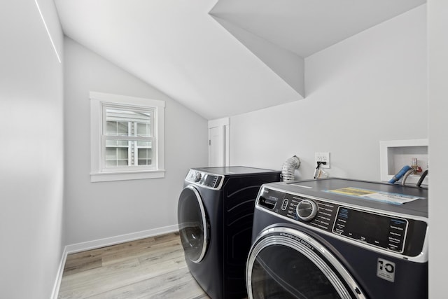 washroom featuring light hardwood / wood-style floors and washing machine and clothes dryer