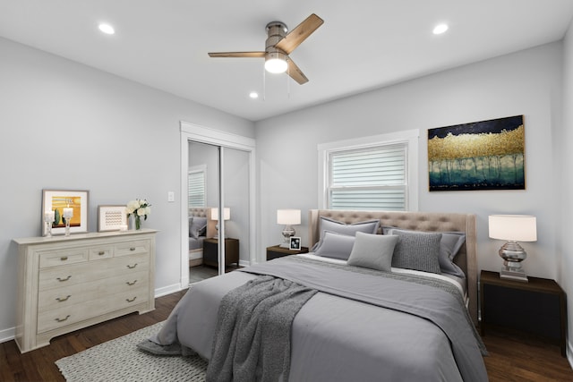 bedroom with a closet, dark hardwood / wood-style floors, and ceiling fan