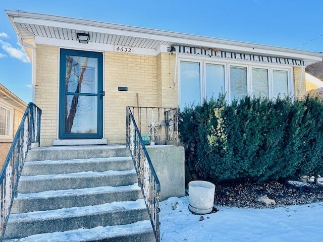 view of snow covered property entrance