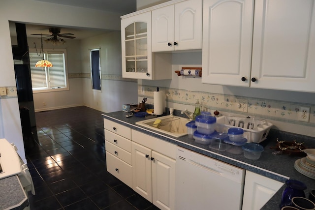 kitchen featuring ceiling fan, dark tile patterned flooring, sink, white dishwasher, and white cabinets