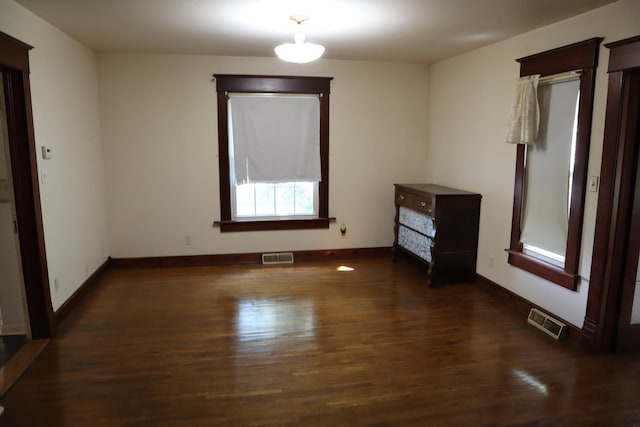 spare room with dark hardwood / wood-style flooring