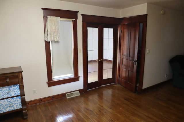 doorway to outside with dark wood-type flooring and french doors