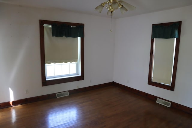 unfurnished room featuring ceiling fan and dark wood-type flooring