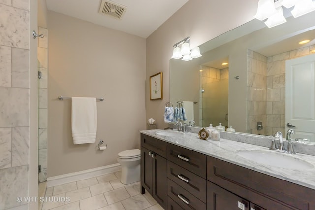 bathroom featuring walk in shower, vanity, toilet, and tile patterned flooring