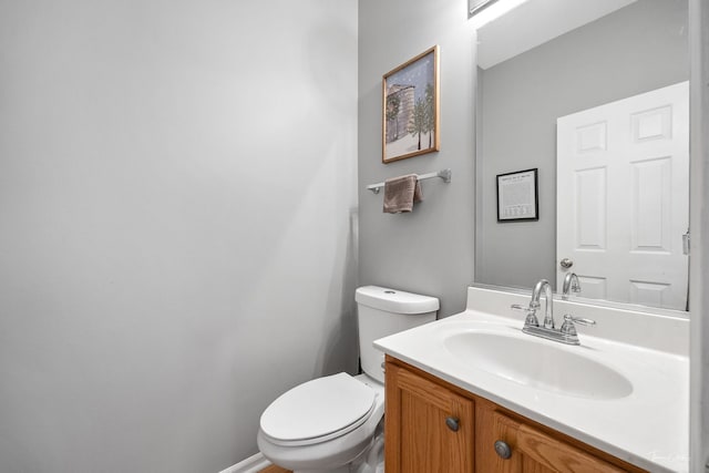 bathroom featuring toilet and vanity