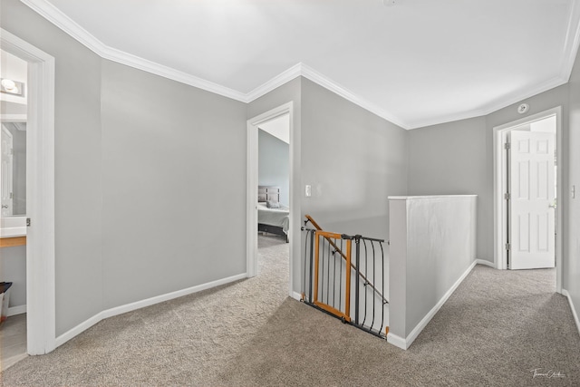 hallway featuring light colored carpet and crown molding