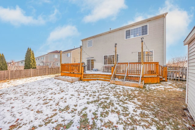 snow covered property featuring a wooden deck