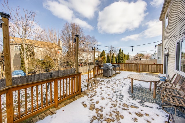 snow covered deck featuring grilling area