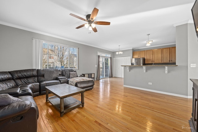 living room with crown molding, light hardwood / wood-style floors, and ceiling fan