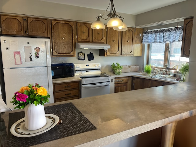 kitchen featuring pendant lighting and white appliances