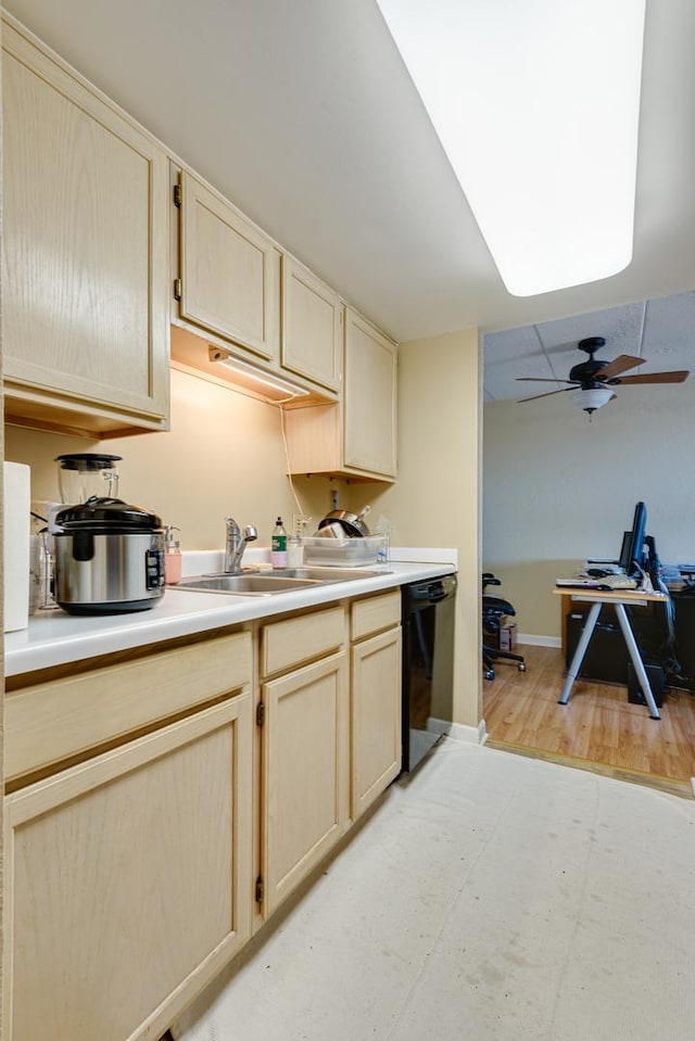 kitchen featuring light brown cabinetry, dishwasher, sink, ceiling fan, and light hardwood / wood-style flooring