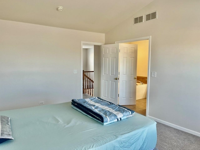 carpeted bedroom with lofted ceiling